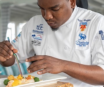 Chef plating a meal in Barbados hotel photo shoot