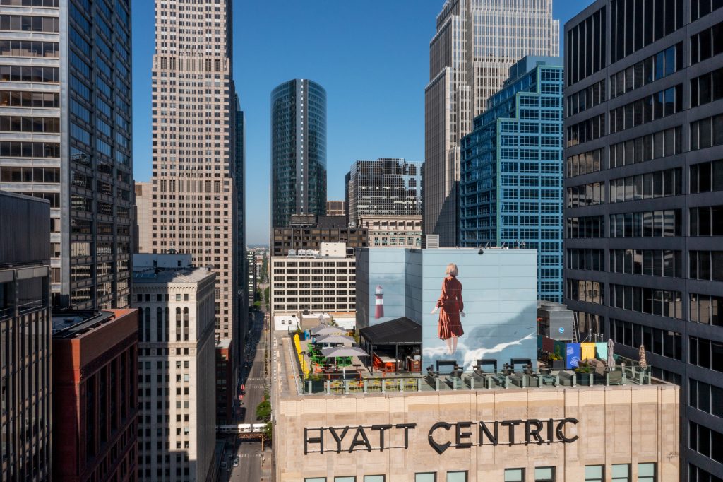 Hyatt Centric rooftop with branding and mural surrounded by downtown Chicago.