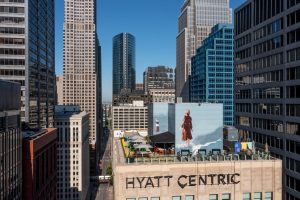 Hyatt Centric rooftop with branding and mural surrounded by downtown Chicago.