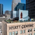 High rooftop view of Hyatt Centric’s Aire bar surrounded by Chicago skyscrapers.