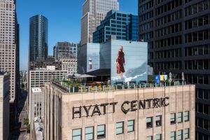 High rooftop view of Hyatt Centric’s Aire bar surrounded by Chicago skyscrapers.