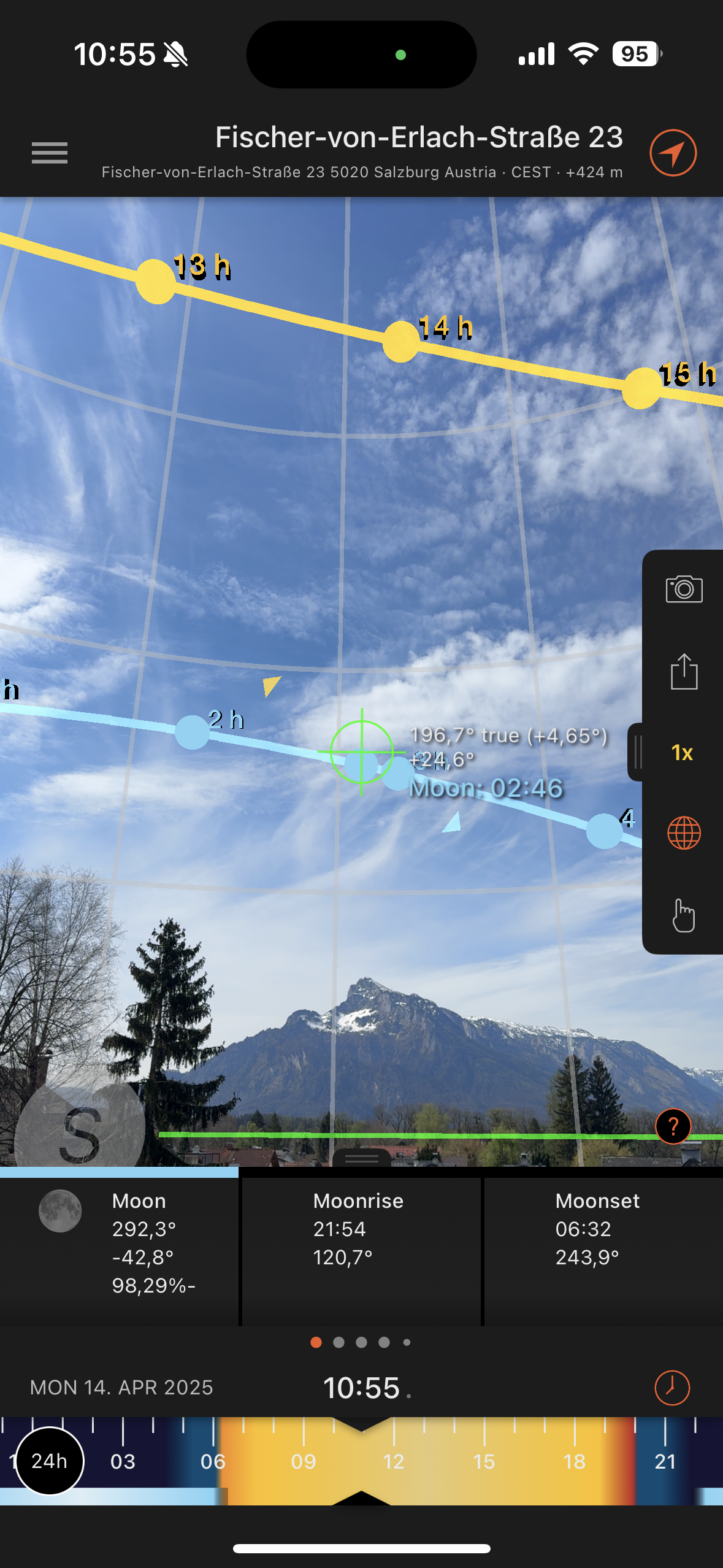 Augmented reality sun path overlay from Sun Surveyor showing sun movement against mountain backdrop.