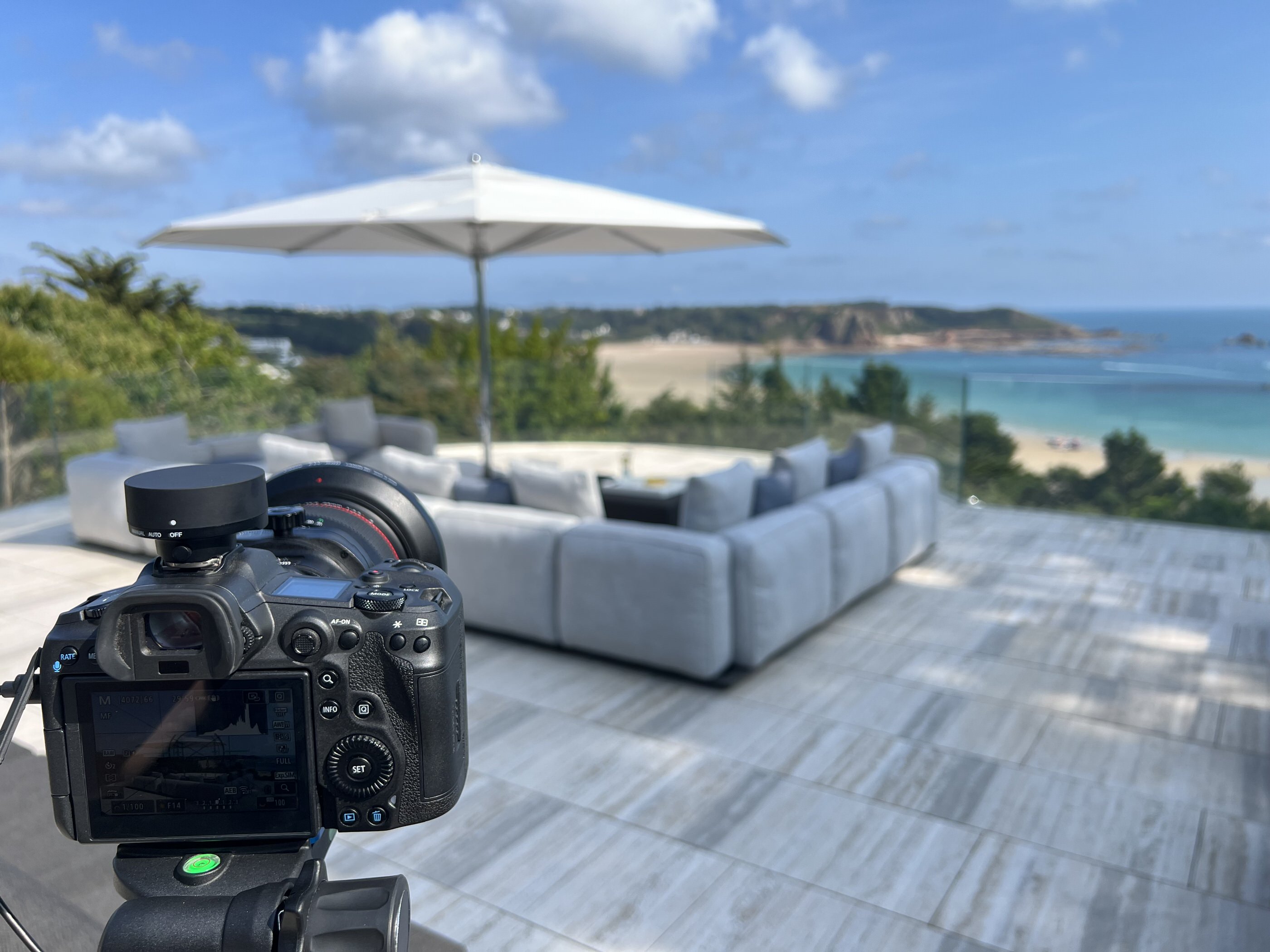 Camera setup overlooking a coastal hotel terrace during a hotel photography pre-shoot call.