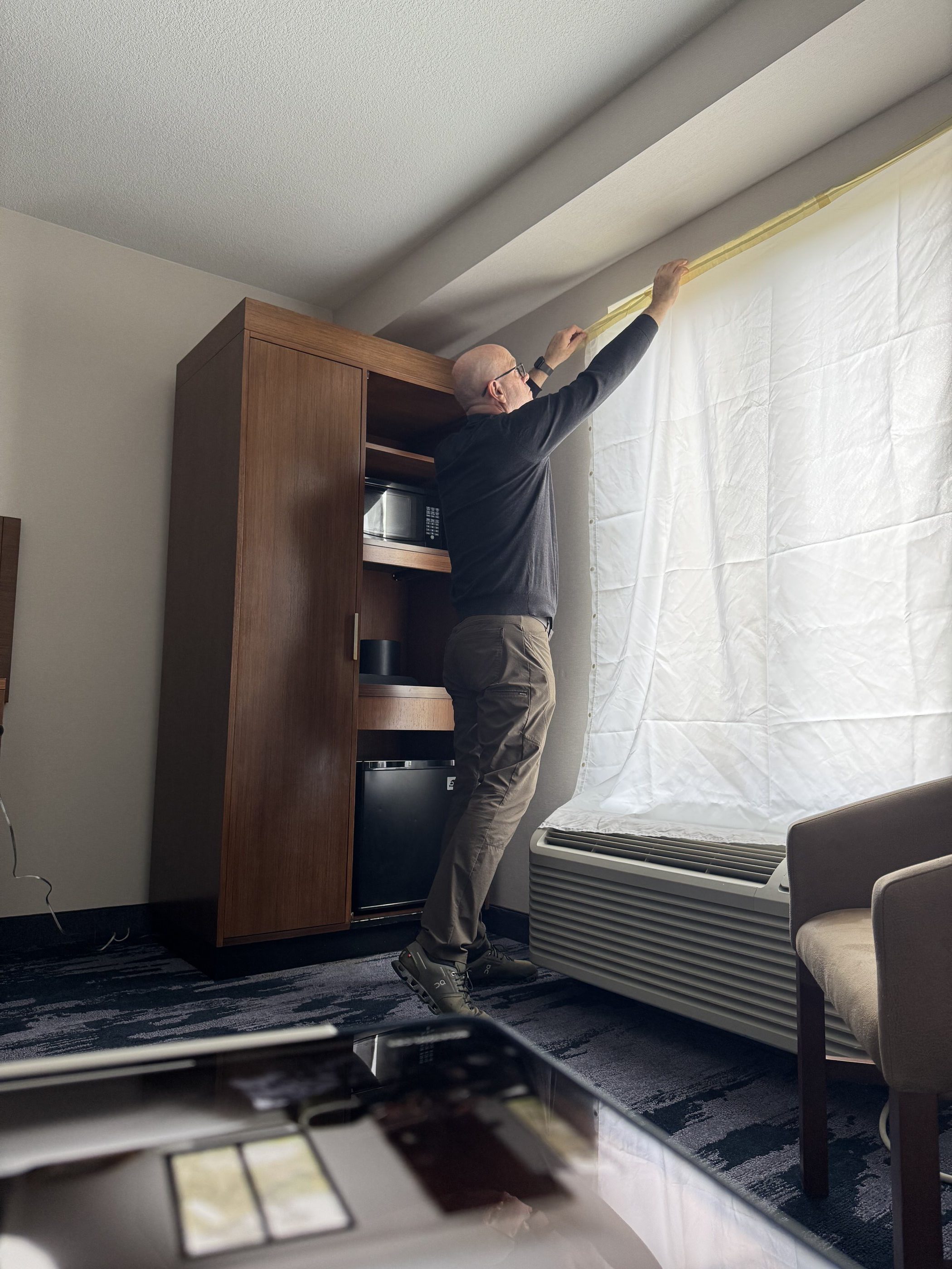 adjusting light-blocking sheets over window during room renovation at Fairfield Inn Mission Viejo