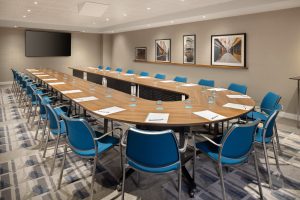 U-shaped meeting room at Le Méridien Étoile with modern chairs and wall art.