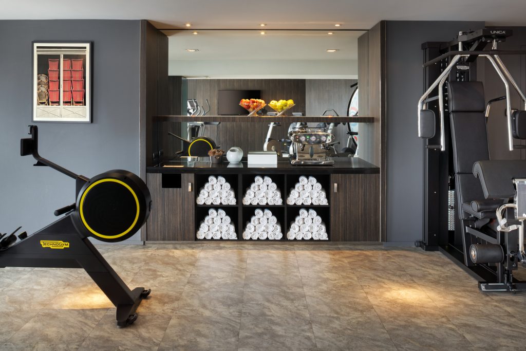 Towel and hydration station in Le Méridien Étoile fitness center.