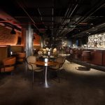 Evening bar at Sheraton Muscat with moody lighting and modern seating.