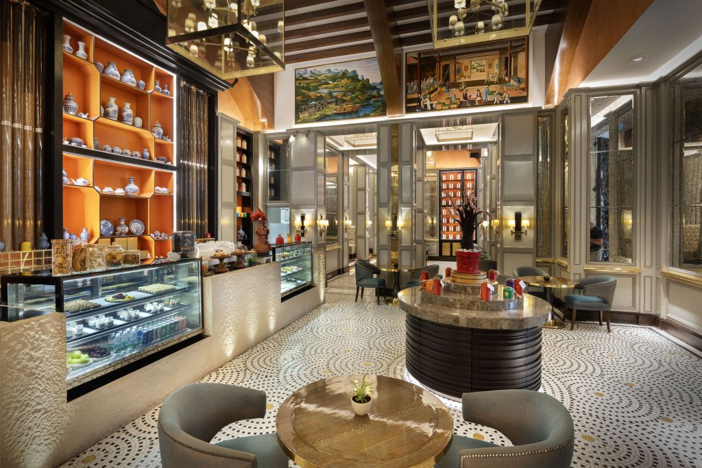 Stylish café at Sheraton Muscat with glass cases and designer lighting.