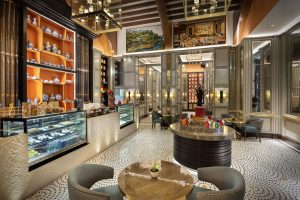 Stylish café at Sheraton Muscat with glass cases and designer lighting.