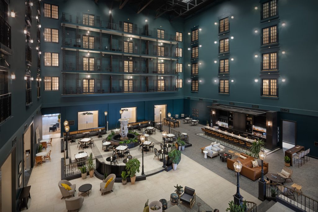 Atrium overview at DoubleTree Lexington featuring bar, casual seating, and upper balcony rooms.