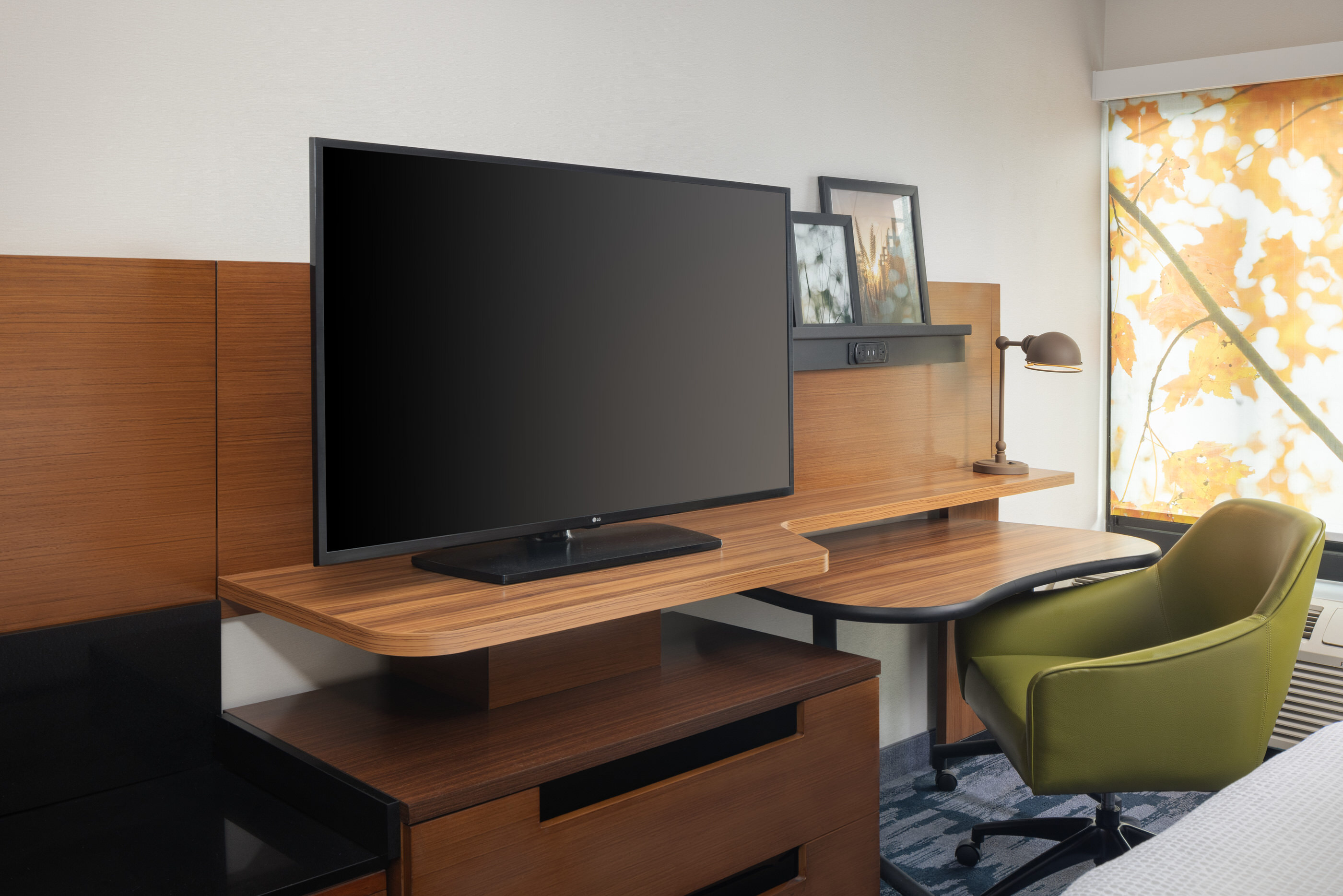 Renovated work desk area with flat-screen TV in a modern guest room at Fairfield Inn Mission Viejo, California