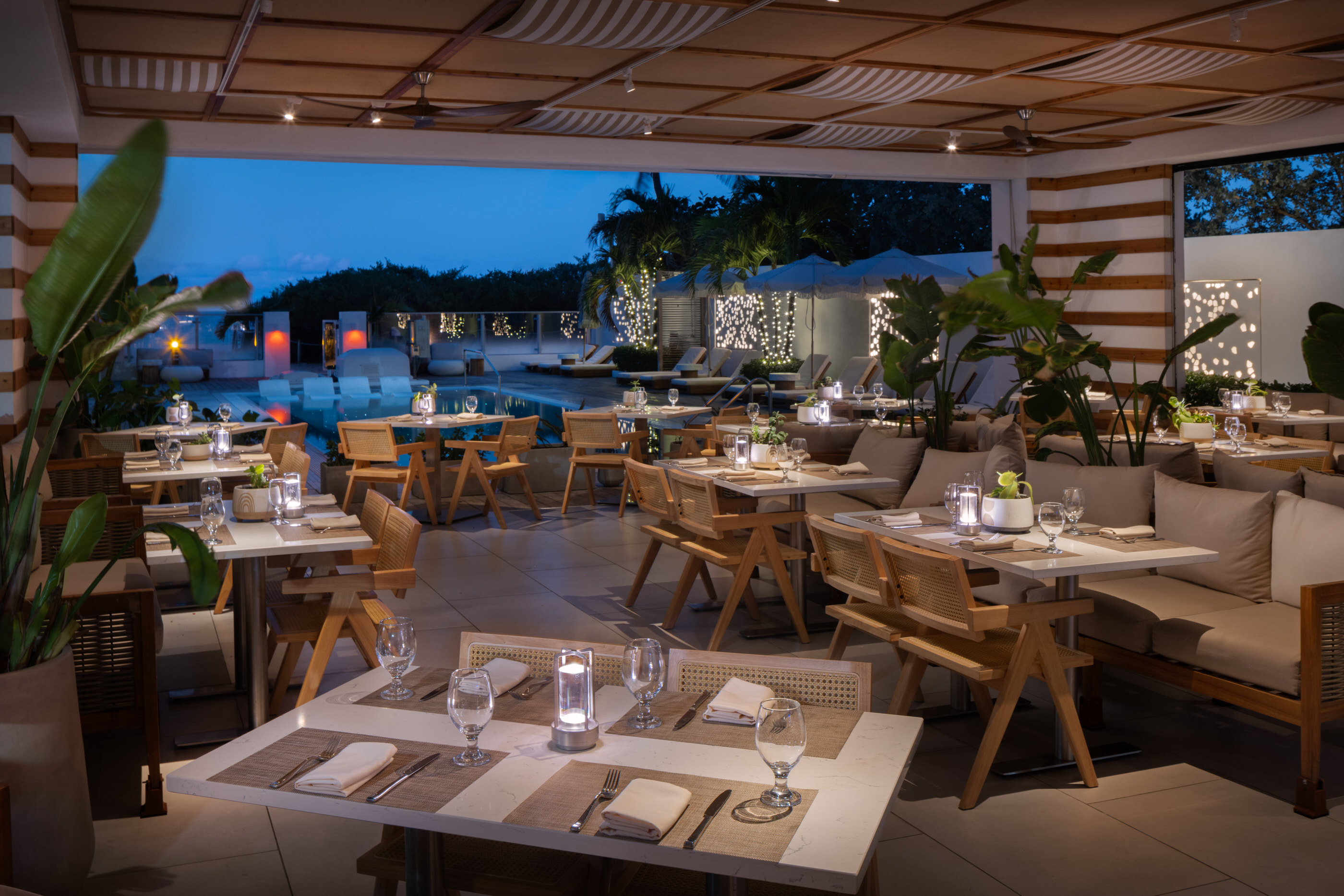 Twilight dining scene with soft lighting and table settings