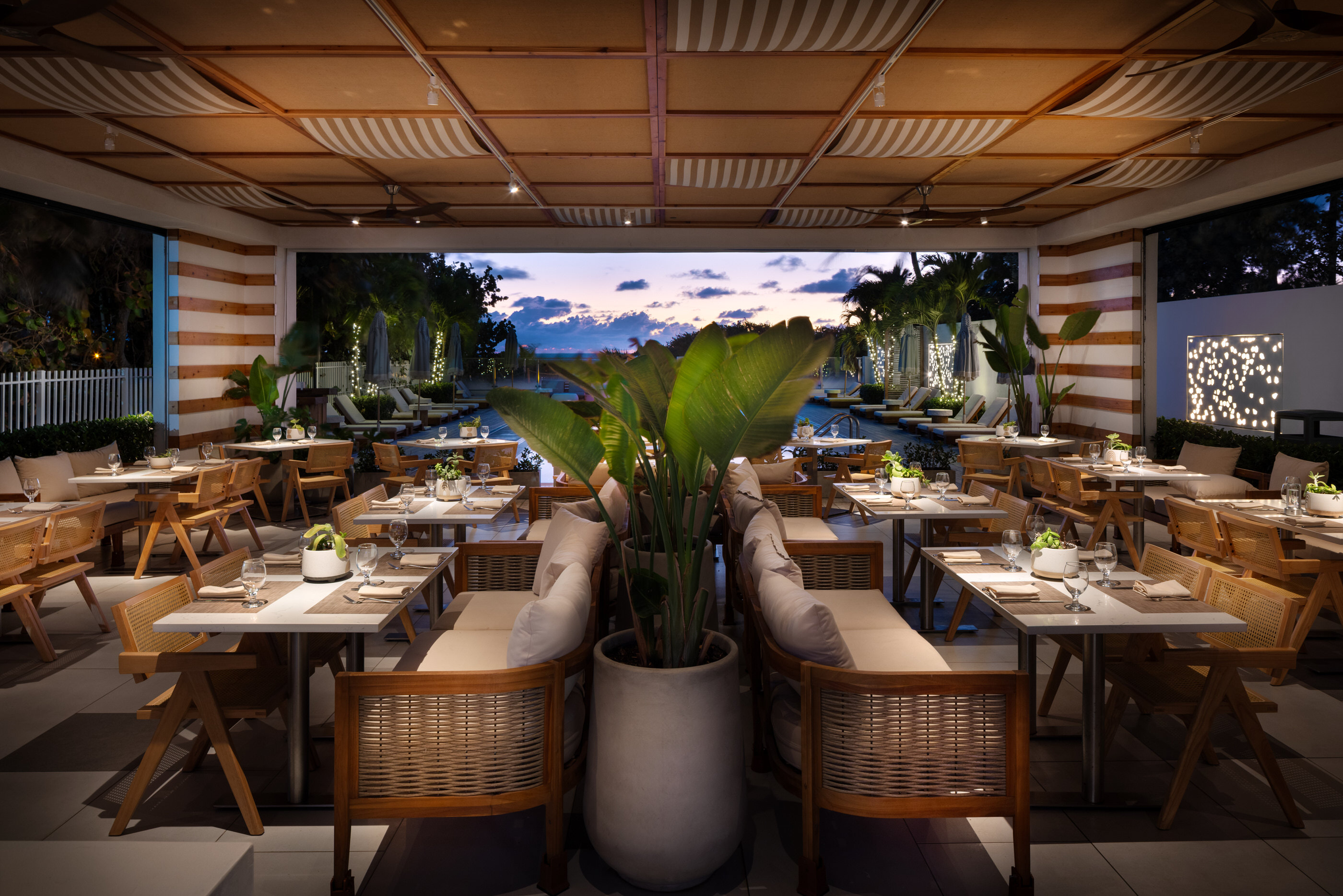 Mediterranean restaurant at twilight with lush plants