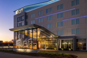 Aloft Wichita hotel entrance at dusk with branded signage and canopy.