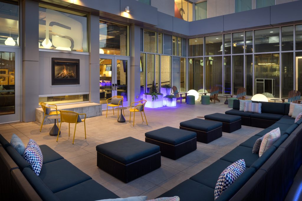 Outdoor lounge with fire pit and seating at Aloft Wichita.