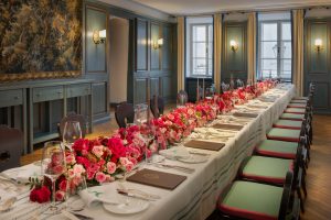 Side angle of a private dining table with lush pink florals at Goldener Hirsch