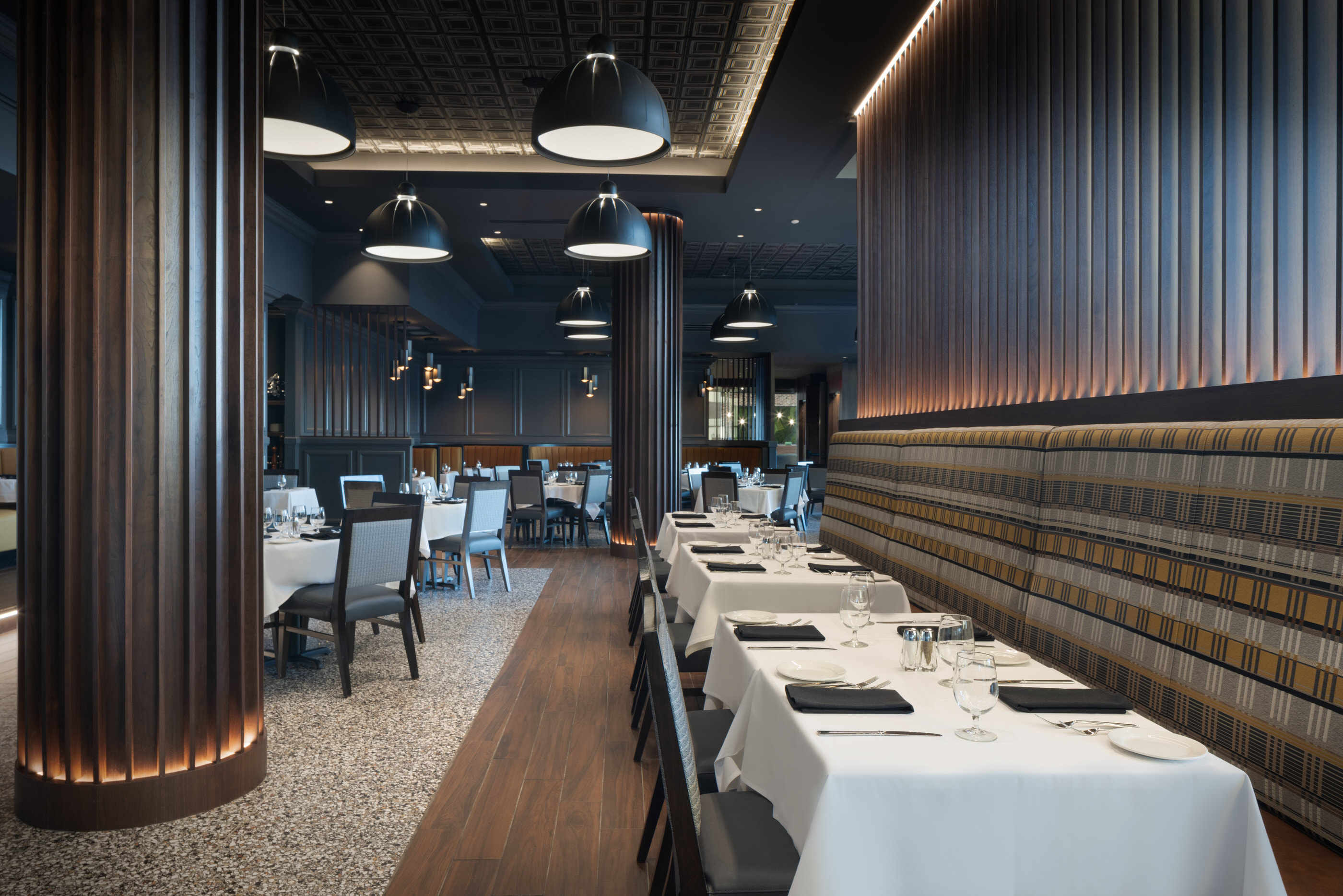 How to prepare a hotel for a photo shoot. Upscale booth dining area at Tony’s Bowling Green with ambient lighting and modern design