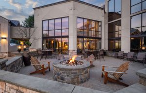 Firepit lounge area with Adirondack chairs at Holiday Inn Lake George resort