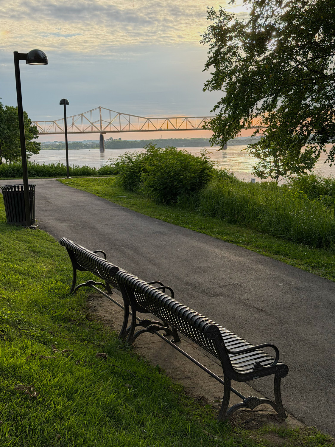Riverside benches facing a bridge over the Ohio River