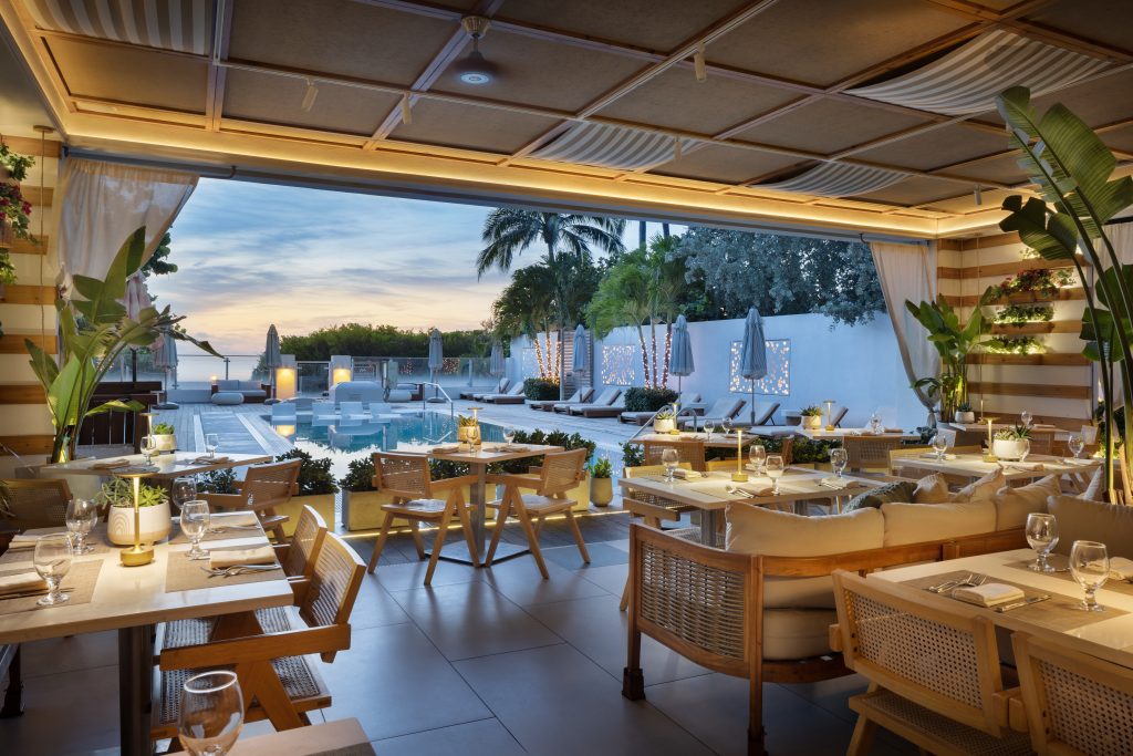 Kalypso Mediterranean restaurant beside the pool at MB Hotel Miami Beach at dusk