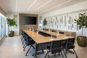 Modern meeting room at MB Hotel Miami Beach arranged as a boardroom with screen and conference equipment
