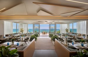 Ocean-facing rooftop restaurant at MB Hotel Miami Beach with symmetrical table settings and terrace view