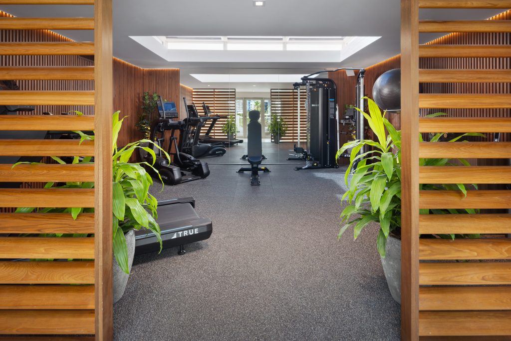 New MB Hotel Miami Beach gym with timber screens, plants, cardio machines and strength equipment