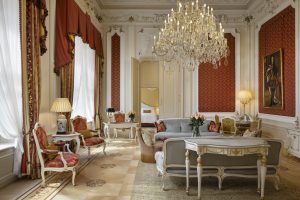 Elegant suite sitting room with antique furniture, soft daylight and ornate detailing at Hotel Imperial Vienna